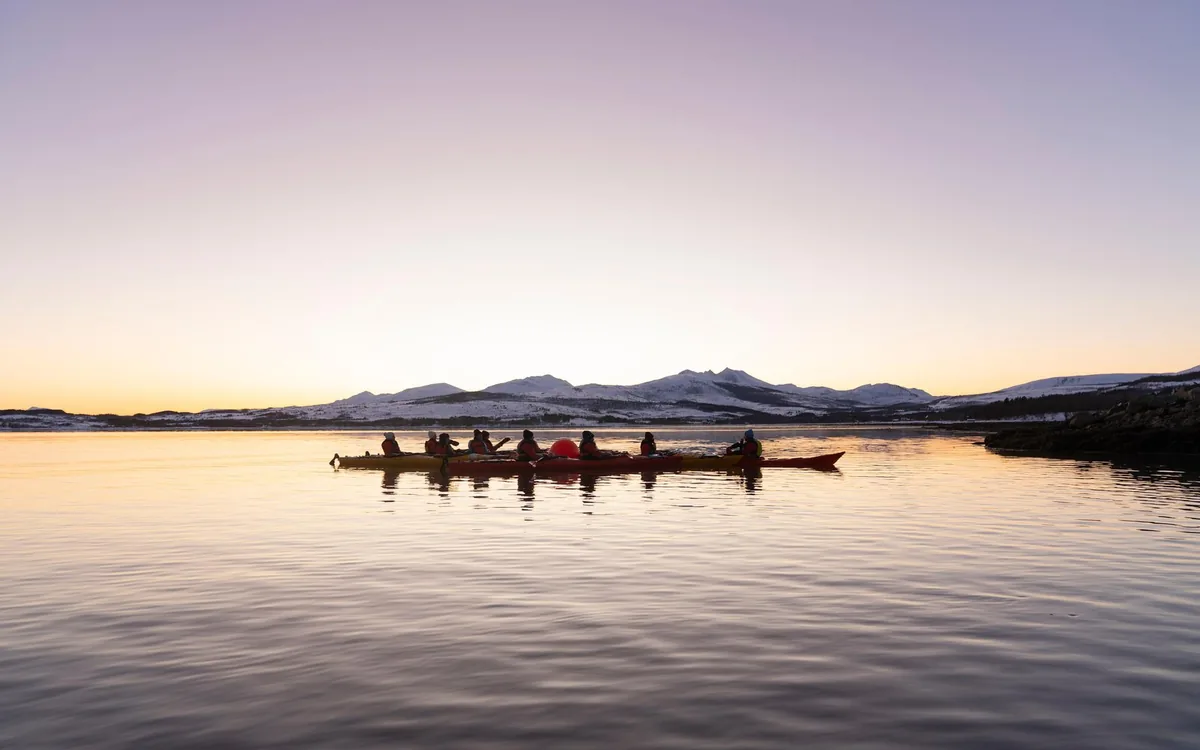 Sea kayaks on an Arctic fjord near Tromso at sunset