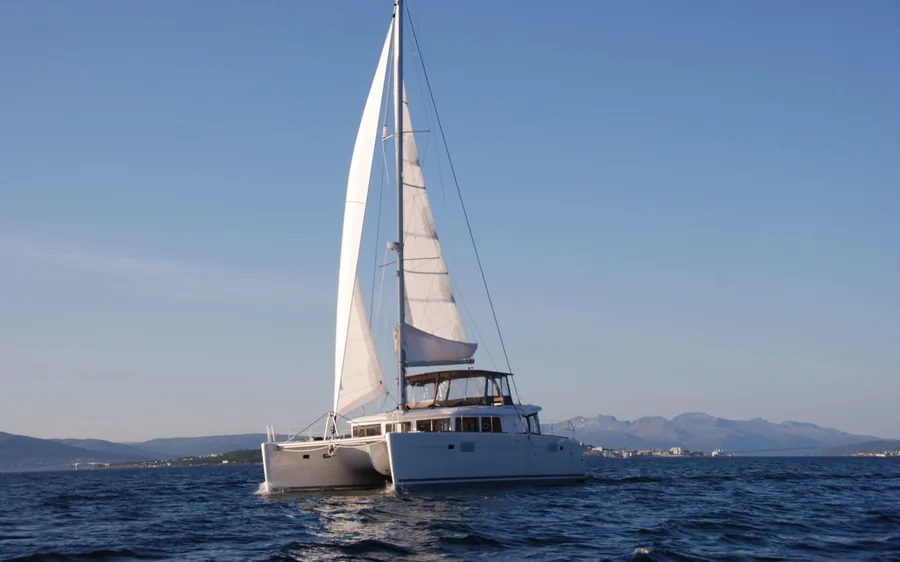 A sailing catamaran in a fjord near Tromso