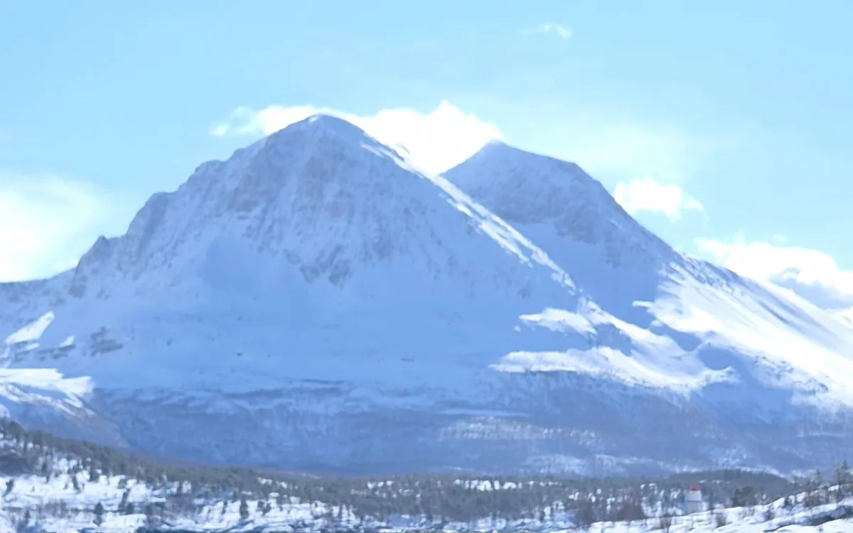 Snow-covered peaks above a fjord near Tromso